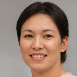 Joyful asian adult female with short  brown hair and brown eyes