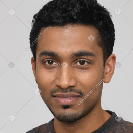 Joyful black young-adult male with short  black hair and brown eyes