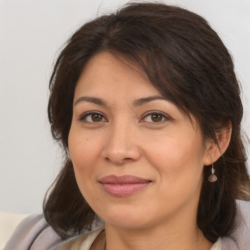 Joyful white adult female with medium  brown hair and brown eyes