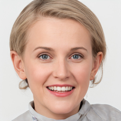 Joyful white young-adult female with medium  brown hair and blue eyes