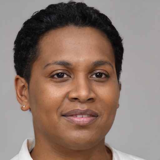 Joyful black young-adult female with short  brown hair and brown eyes