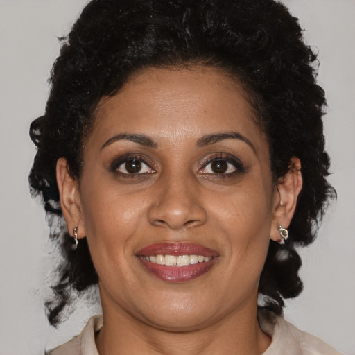 Joyful black young-adult female with medium  brown hair and brown eyes