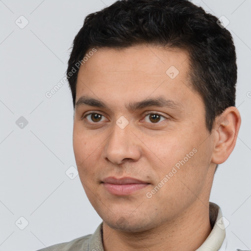 Joyful white young-adult male with short  black hair and brown eyes