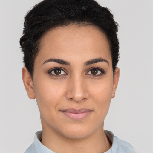 Joyful latino young-adult female with short  brown hair and brown eyes