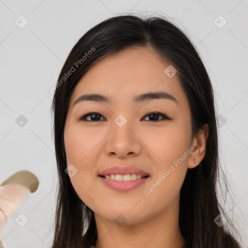 Joyful asian young-adult female with long  brown hair and brown eyes