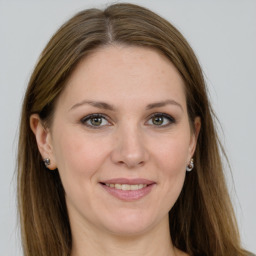 Joyful white young-adult female with long  brown hair and grey eyes