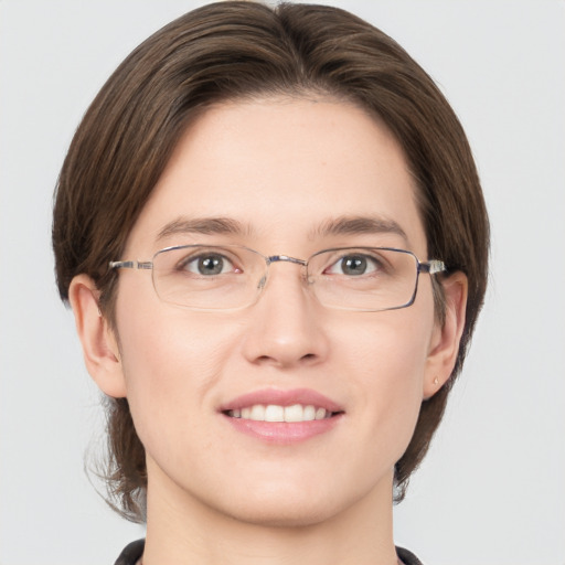 Joyful white young-adult female with medium  brown hair and green eyes