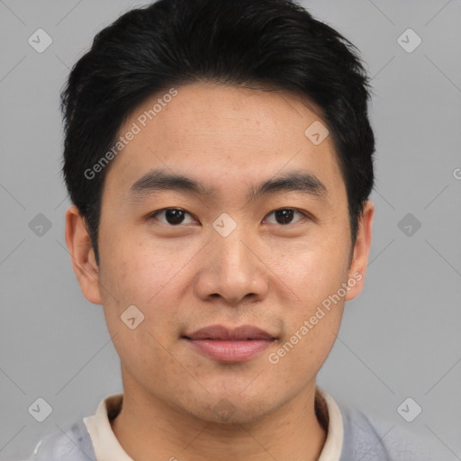 Joyful asian young-adult male with short  black hair and brown eyes