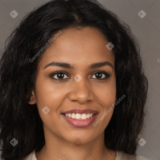 Joyful black young-adult female with long  brown hair and brown eyes