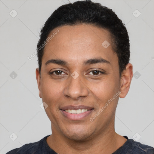 Joyful latino young-adult male with short  black hair and brown eyes