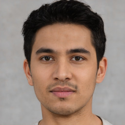 Joyful asian young-adult male with short  black hair and brown eyes