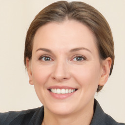 Joyful white adult female with medium  brown hair and grey eyes