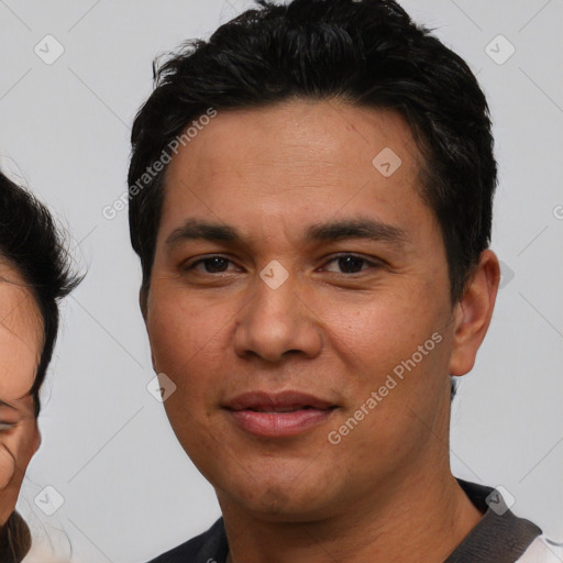 Joyful white young-adult male with short  black hair and brown eyes