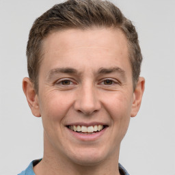 Joyful white adult male with short  brown hair and grey eyes