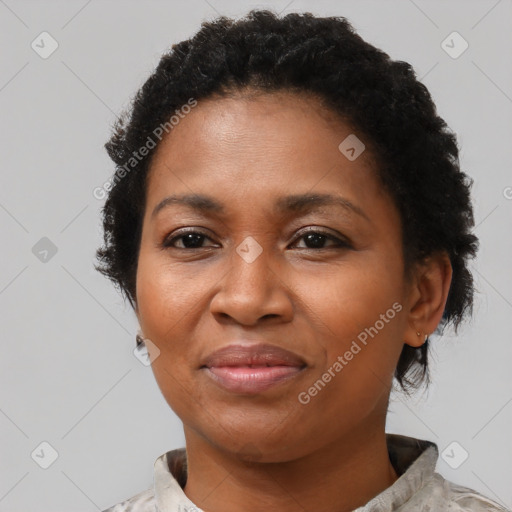 Joyful black adult female with short  brown hair and brown eyes