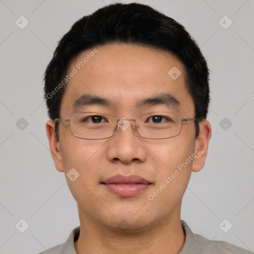 Joyful asian young-adult male with short  black hair and brown eyes