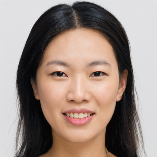 Joyful asian young-adult female with long  brown hair and brown eyes