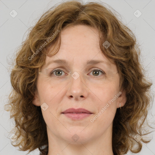 Joyful white adult female with medium  brown hair and blue eyes