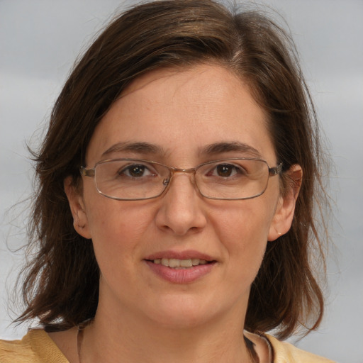 Joyful white adult female with medium  brown hair and brown eyes