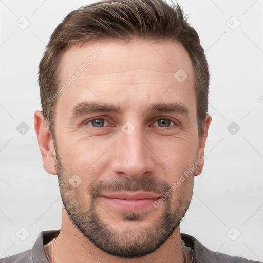 Joyful white young-adult male with short  brown hair and grey eyes