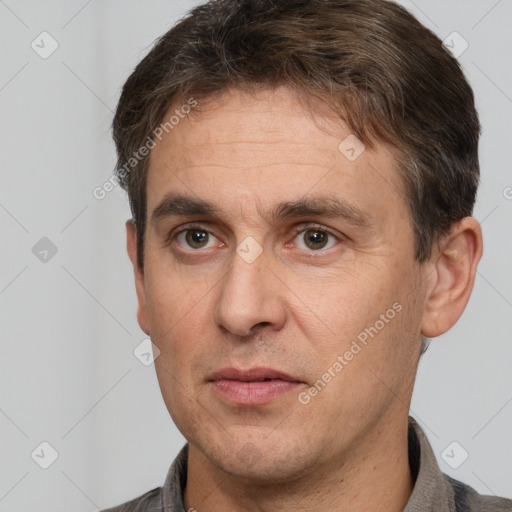 Joyful white adult male with short  brown hair and brown eyes