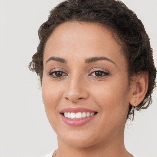 Joyful white young-adult female with short  brown hair and brown eyes