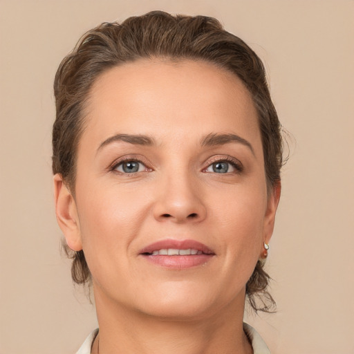 Joyful white young-adult female with medium  brown hair and grey eyes