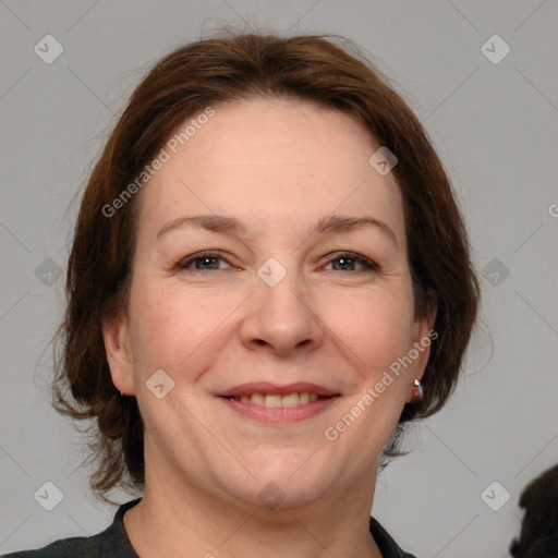 Joyful white adult female with medium  brown hair and grey eyes