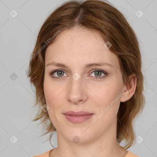 Joyful white adult female with medium  brown hair and green eyes