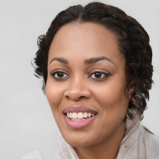 Joyful black young-adult female with medium  brown hair and brown eyes