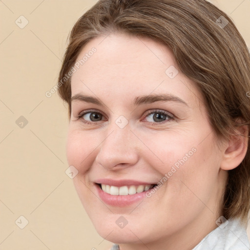 Joyful white young-adult female with medium  brown hair and green eyes