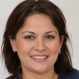 Joyful white adult female with medium  brown hair and brown eyes