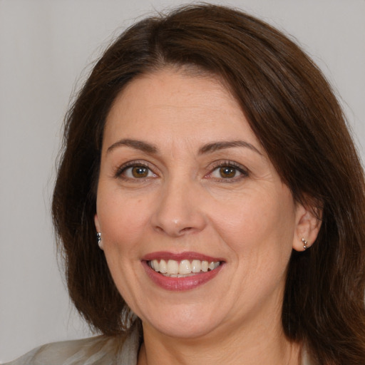 Joyful white adult female with medium  brown hair and brown eyes