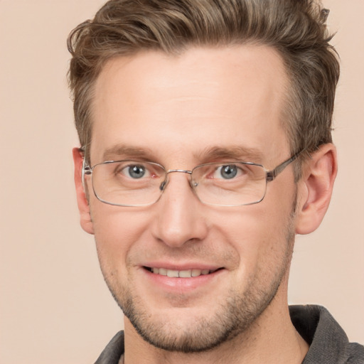 Joyful white adult male with short  brown hair and grey eyes