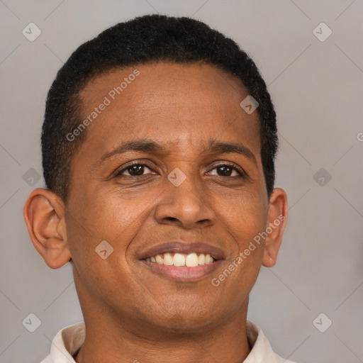 Joyful black adult male with short  brown hair and brown eyes