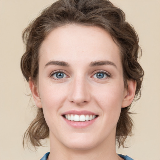 Joyful white young-adult female with medium  brown hair and blue eyes