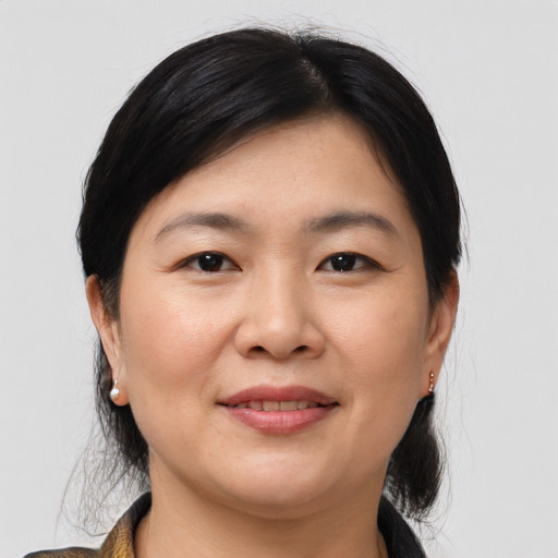 Joyful asian young-adult female with medium  brown hair and brown eyes