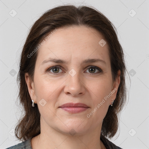 Joyful white adult female with medium  brown hair and grey eyes