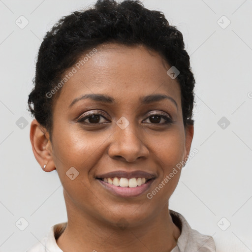 Joyful black young-adult female with short  brown hair and brown eyes