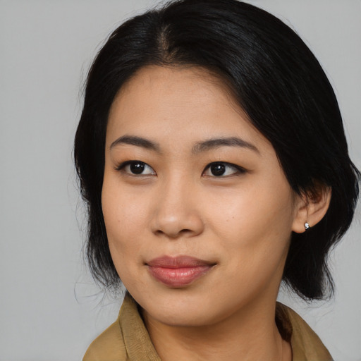 Joyful asian young-adult female with medium  black hair and brown eyes