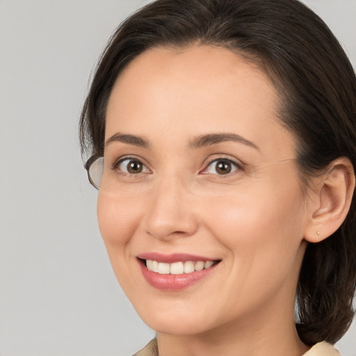 Joyful white young-adult female with medium  brown hair and brown eyes