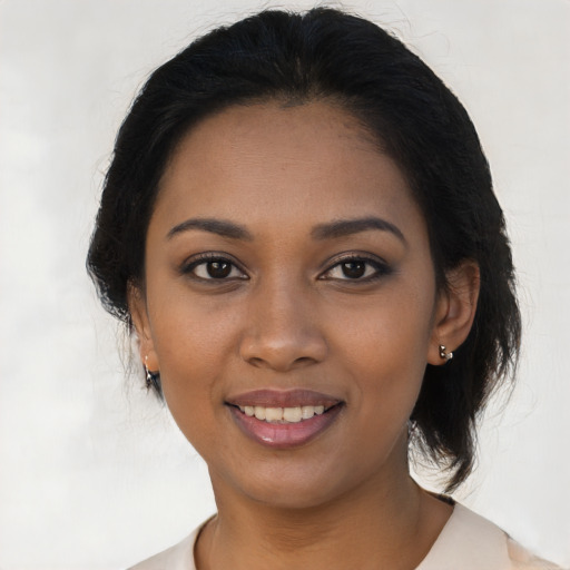 Joyful black young-adult female with medium  brown hair and brown eyes