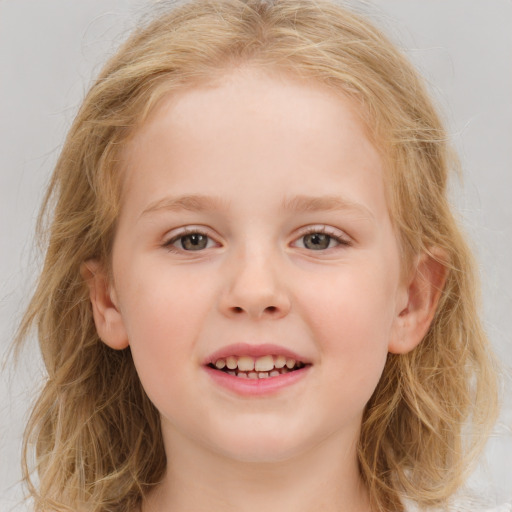 Joyful white child female with medium  brown hair and blue eyes