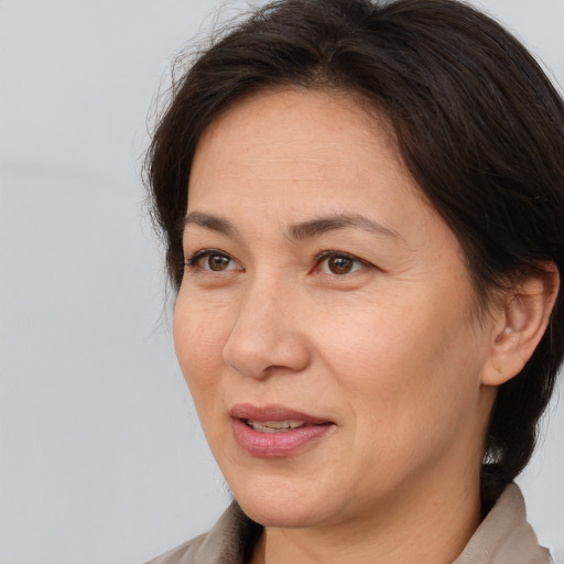 Joyful white adult female with medium  brown hair and brown eyes