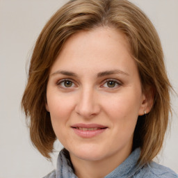 Joyful white young-adult female with medium  brown hair and blue eyes