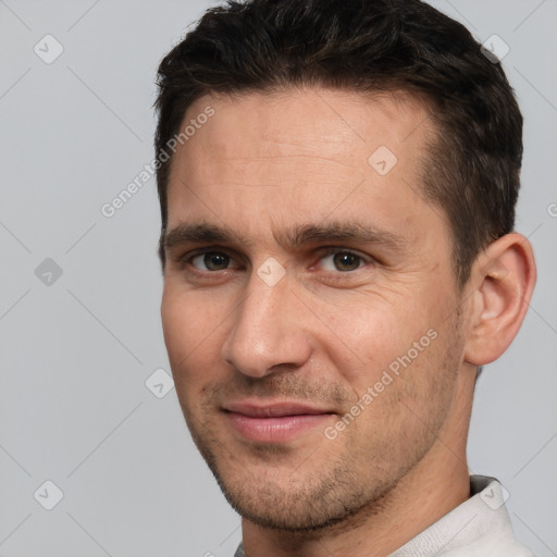 Joyful white adult male with short  brown hair and brown eyes