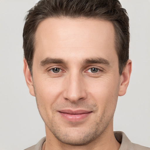 Joyful white young-adult male with short  brown hair and brown eyes