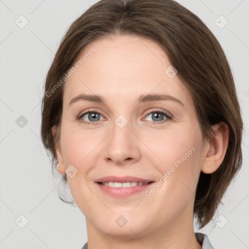 Joyful white young-adult female with medium  brown hair and grey eyes