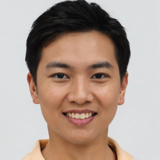 Joyful asian young-adult male with short  brown hair and brown eyes