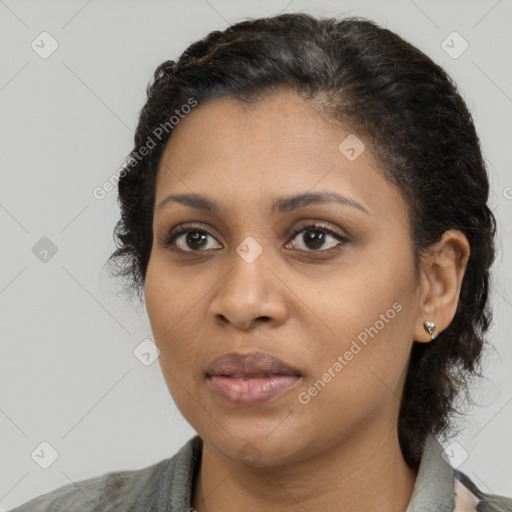 Joyful black young-adult female with medium  brown hair and brown eyes